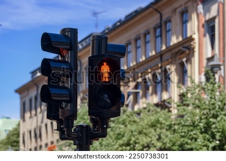 Close up of road signal against buildings in city