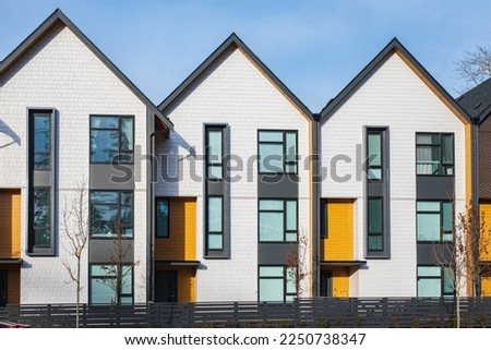 New residential townhouses. Modern apartment buildings in BC Canada. Modern complex of apartment buildings. Concept of real estate development, house for sale and housing market. Copyspace Royalty-Free Stock Photo #2250738347