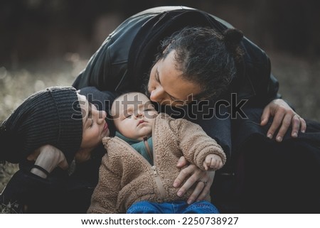New born fall family photo shoot with father kissing baby boy