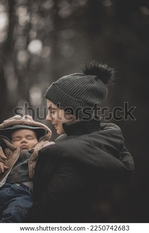 New born family photo shoot in the fall by the woods with mother and baby