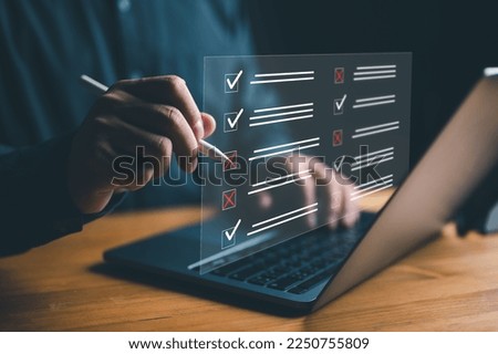 Document management system DMS. Assessment form, questionnaire, checklist and clipboard task management. Businessman working on laptop computer productivity checklist and filling survey form online. Royalty-Free Stock Photo #2250755809