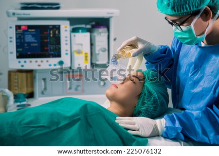 Doctors were anesthetized Women who are surgical patients and the doctor put a mask Royalty-Free Stock Photo #225076132