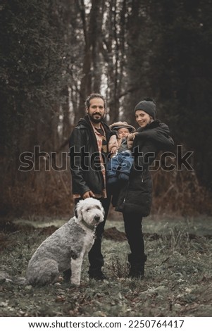 New born family photo shoot in the fall by the woods with family sheep dog