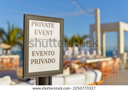 Private event signboard with blurred background.