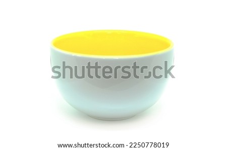 White and yellow ceramic cup, yellow inside.