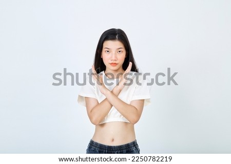 Beautiful young Asian woman Break the bias symbol of woman's international day. Crossed hands