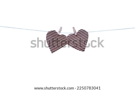 Two heart paper shape hang on wood clothes clip and white string line patterns isolated on white background , clipping path for picture album or documentation