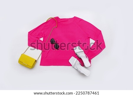 sweaters close up with yellow, handbag,shoes, sunglasses on white background