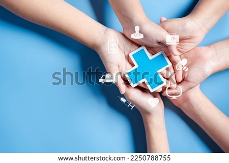 Health insurance concept. Doctor in a white coat uniform hand holding plus and healthcare medical icon, health and access to welfare health concept. Royalty-Free Stock Photo #2250788755