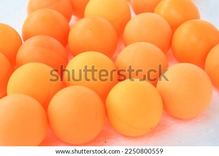 orange ping pong ball on white background