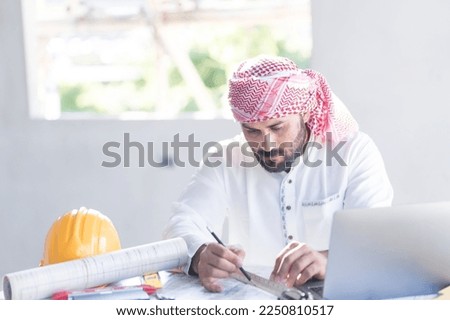 Architect concept, Architects working with blueprints in the office Business accessories (laptop, smartphone, pens, magnifier), accessories for drawing (plans, rulers) and learning on the table