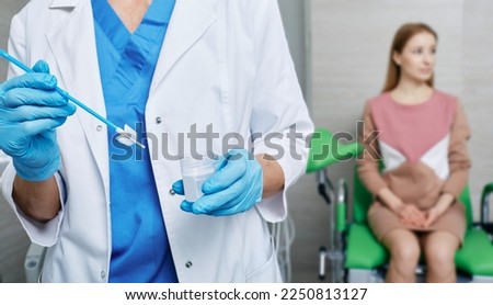 Cytobrush for sampling endocervical cells in doctor hands during PAP test on woman patient in gynecologist's office. PAP test, cervical screening test Royalty-Free Stock Photo #2250813127