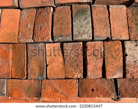 A backdrop of red brick shapes laid out for a walkway