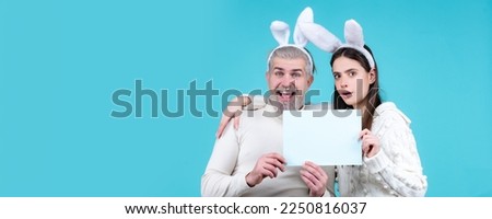 Easter banner, mockup copy space, poster flyer header for website template. Easter couple having fun with rabbit ears. Easter egg hunting. Bunny couple hold board paper for text.