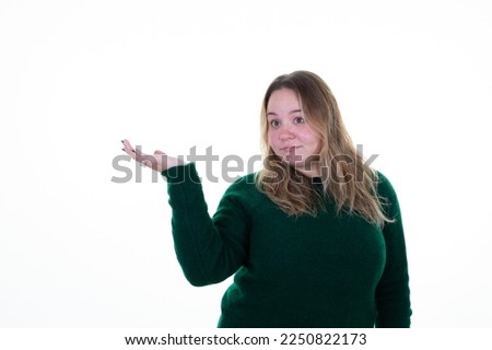 Young curvy blond woman on white background presenting an idea product side