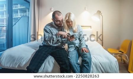 Young couple is arguing, girl screaming and scolding her husband, sitting on couch. Man was guilty, problems in relationships and difficulties in understanding