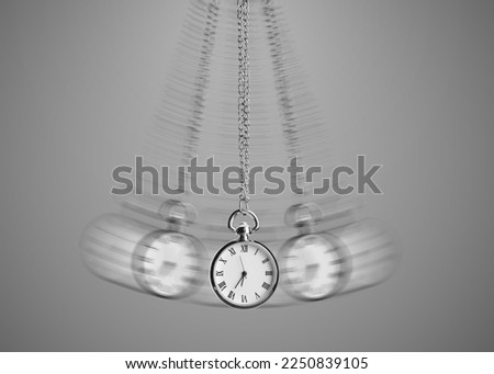 Hypnosis session. Vintage pocket watch with chain swinging on grey background, motion effect Royalty-Free Stock Photo #2250839105