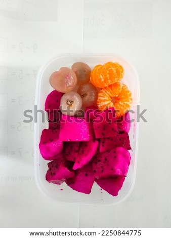 Assorted fresh fruit in plastic containers in the photo from above on a white background.  Great for background, fruit, fresh, food, delicious, diet, ripe, nature, organic, nutrition, summer, healthy.