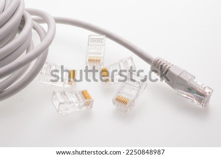 Several rg 45 connectors for internet cables lie on a light background. Close-up