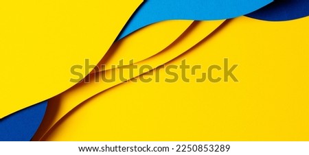 Abstract colored paper texture background. Minimal paper cut composition with layers of geometric shapes and lines in light blue, navy blue, yellow colors