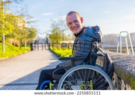 Portrait of a disabled person in a wheelchair in the city sunset