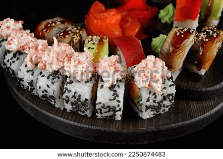 Sushi rolls in assortment on a black background