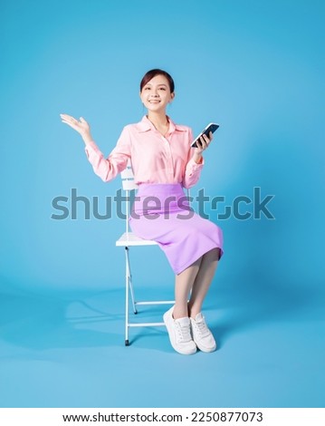 Photo of young Asian businesswoman sitting on chair