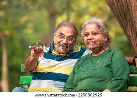 happy Old couple spending time together and watching some opposite site and pointing there. Royalty-Free Stock Photo #2250882925