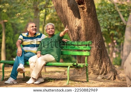 happy Old couple spending time together and watching some opposite site and pointing there. Royalty-Free Stock Photo #2250882969