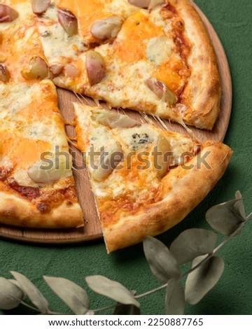 Traditional Italian pizza with pear and gorgonzola cheese. Mediterranean food. Vegetarian dish. Close-up. Green background. Copy space. Top view.