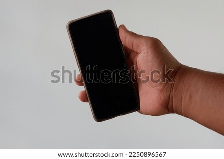 a man hand holding phone with white background 