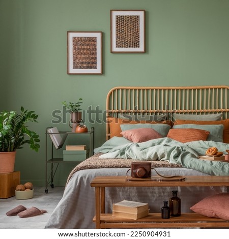 Stylish bedroom interior design with mock up poster frame, bamboo bed, night table, plants, folding screen and creative home accessories. Eucalyptus wall. Template. Copy space.