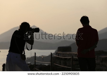 a silhouette of a photographer in action