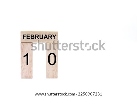 February 10 displayed wooden letter blocks on white background with space for print. Concept for calendar, reminder, date. 