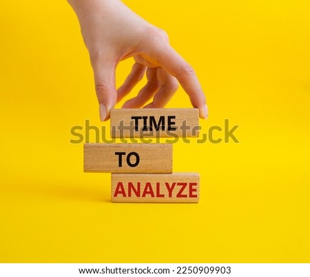 Time to Analyze symbol. Concept word Time to Analyze on wooden blocks. Businessman hand. Beautiful yellow background. Business and Time to Analyze concept. Copy space