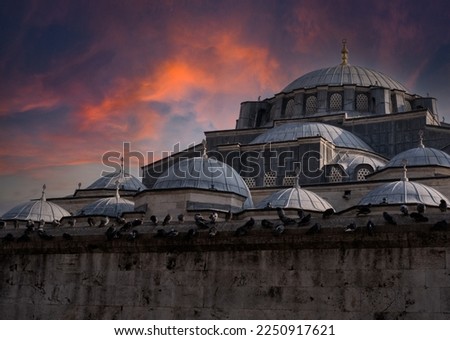 Mosque Against the Sky at Sunset. Red Cloudy Background and Historical Mosque.