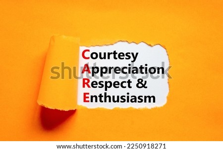 CARE symbol. Concept words CARE courtesy appreciation respect and enthusiasm on white paper on beautiful orange background. Business CARE courtesy appreciation respect enthusiasm concept. Copy space.
