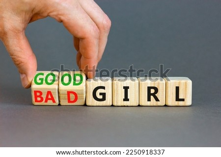 Good or bad girl symbol. Concept word Good girl Bad girl on wooden cubes. Businessman hand. Beautiful grey table grey background. Business psychological good or bad girl concept. Copy space.