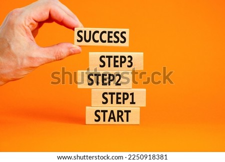 Strat, step and success symbol. Concept words Start step 1 2 3 success on wooden blocks on a beautiful orange table orange background. Businessman hand. Business start step 1 2 3 to success concept. Royalty-Free Stock Photo #2250918381