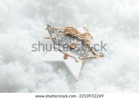 A nice New Year's toy. New Year's decor. Preparation for the holiday. White snowy background. Close up. COPY SPACE.