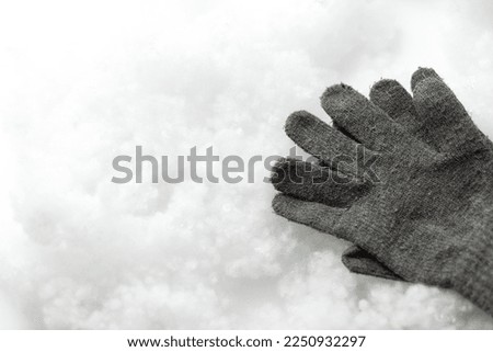 Warm gloves on a white background. Snowy background. Close up. COPY SPACE