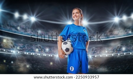  Portrait of young female soccer player with soccer ball standing in the big stadium.