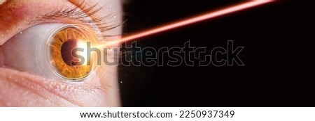 laser eye surgery or lasik concept, close up of female eye with beam of light hitting the irs Royalty-Free Stock Photo #2250937349