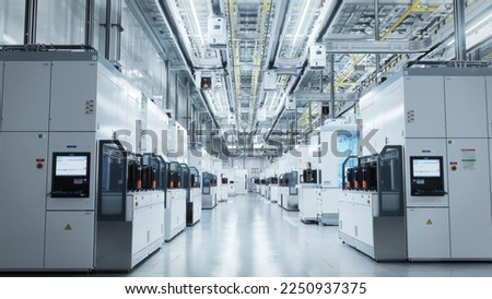 Wide shot of Bright Advanced Semiconductor Production Fab Cleanroom with Working Overhead Wafer Transfer System. Computer Chip Manufacturing Process. Royalty-Free Stock Photo #2250937375