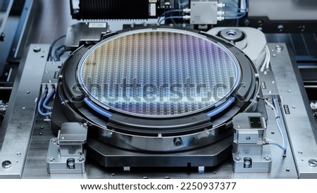 Silicon Wafer inside Photolithography Machine. Shot of a Wafer during Semiconductor and Computer Chip Manufacturing at Fab or Foundry. Royalty-Free Stock Photo #2250937377