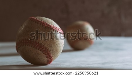 Close up of baseballs for sport in cinematic style of retro equipment with copy space on dark texture background.