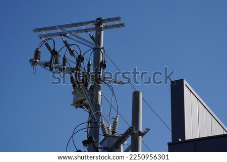 Panoramic view of electric power transmission lines at daytime. High voltage switchgear and power generation equipment.