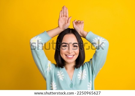 Photo of cheerful smiling satisfied bob black hair hands bunny playing childish have fun wear turquoise pullover isolated on yellow color background
