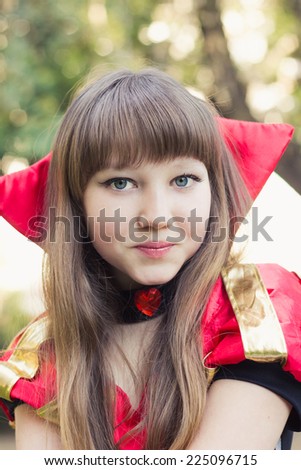 Cute young girl in a card's queen costume. Toned image