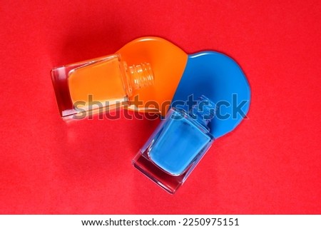 close up of a nail polish bottle and drop on red background, Mockup for branding and packaging presentation